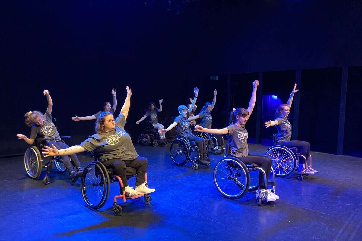 Wheelchair dancers performing together on stage